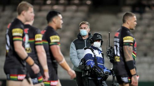 Media broadcast members are seen wearing masks and gloves before the round seven NRL match between the Penrith Panthers and the South Sydney Rabbitohs.