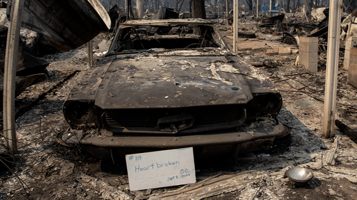 A sign that reads "Heart broken" is displayed in front of a destroyed vehicle at Coleman Creek Estates mobile home park in Phoenix, Ore., Thursday, Sept. 10, 2020. The area was destroyed when a wildfire swept through on Tuesday, Sept. 8. (AP Photo/Paula Bronstein)