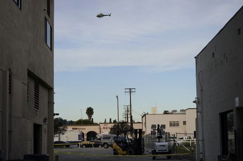 A law enforcement helicopter hovers over Star Dance Studio in Monterey Park.