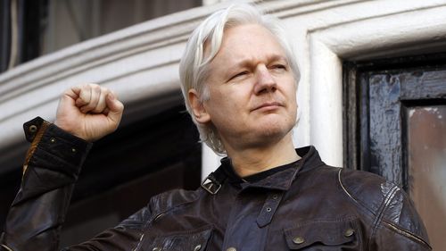 Julian Assange greets supporters outside the Ecuadorian embassy in London in May 2017 (AAP). 