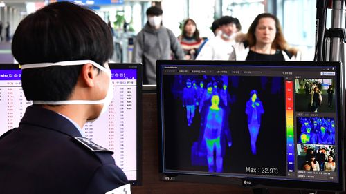 A thermal camera monitor shows the body temperature of passengers arriving from overseas at Incheon International Airport in Incheon, South Korea