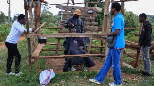 Barber and content creator Safari Martins shaves Ian Njenga in Kiambu, Kenya on Wednesday, November 26.