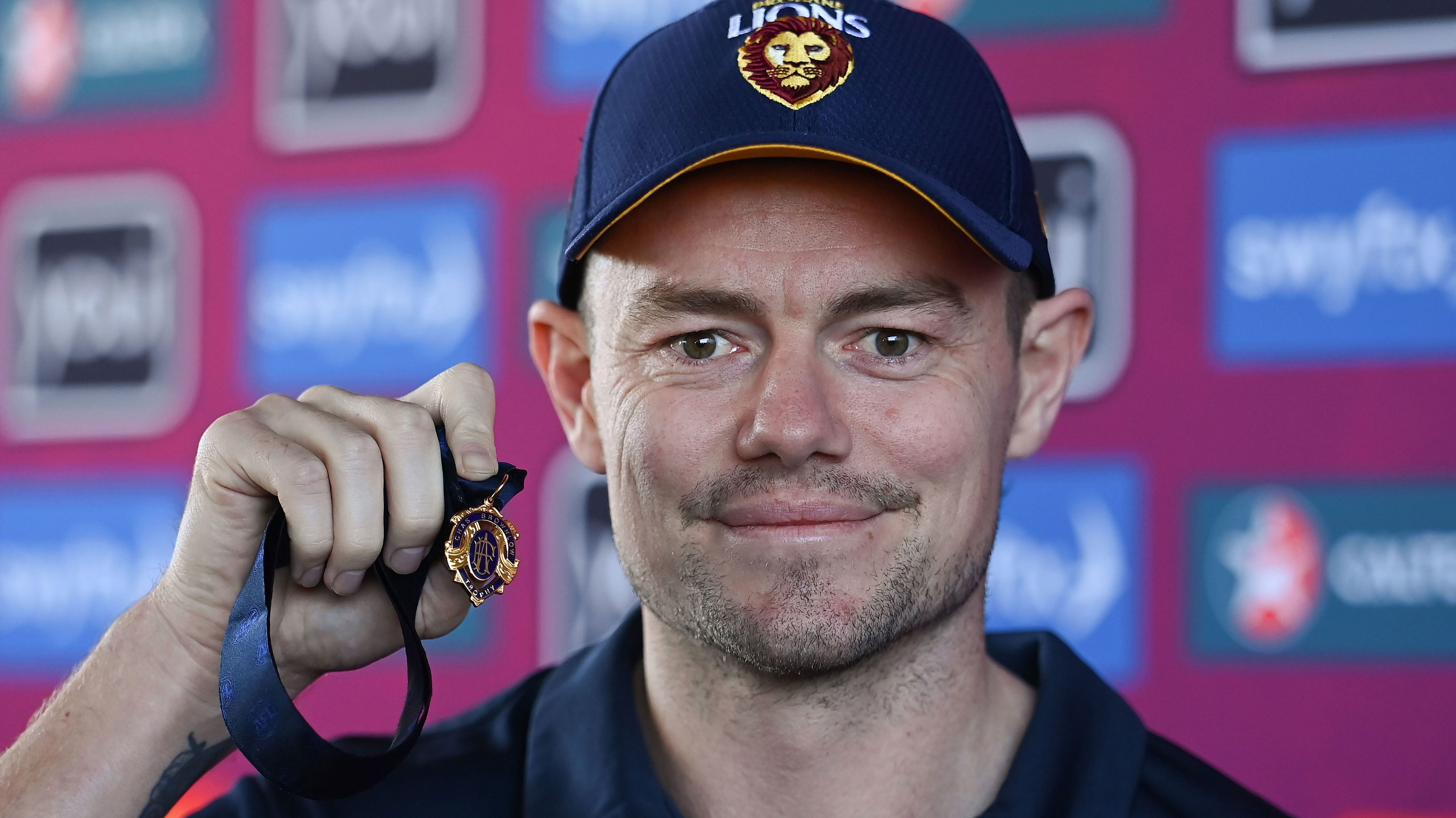 Lachie Neale poses with the Brownlow Medal during a Lions training session. 