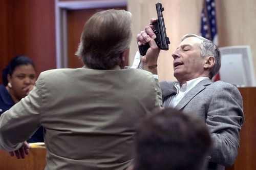 Multi-millionaire murder defendant Robert Durst and his attorney Dick DeGuerin demonstrate how Durst struggled with Morris Black during 2003 testimony in Galveston, Texas. 
