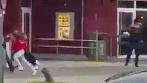 Video has emerged of a man dressed in black opening fire on a crowd outside a Munich McDonalds.