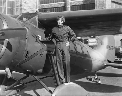 Amelia Earhart (1898-1937), American aviatrix, first woman to cross Atlantic. Photograph showing her with airplane.