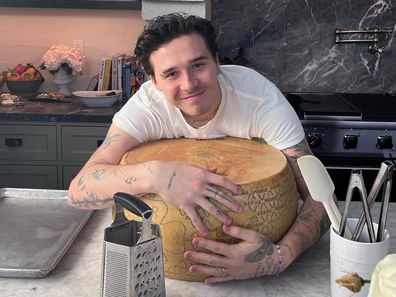 Brooklyn Peltz Beckham hugs a wheel of cheese