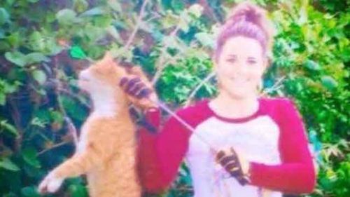Kristen Lindsey with the dead cat.