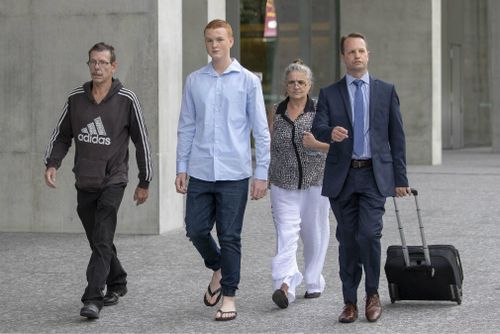 Ryan Hodson (second left) leaves court with supporters and his lawyer. Picture: AAP