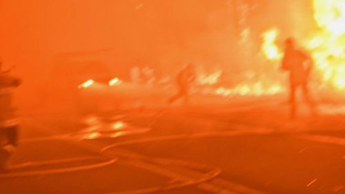 Firefighter a second after being hit by a car in thick smoke as fire roared through eastern Bilpin, December 21, 2019.