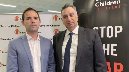 Save the Children's Mat Tinkler (left) and the father of an Australian woman in Syria, Kamalle Dabboussy (right) pose for a photo during a Save the Children Press conference urging the Australian government to do more to get over 60 women and children out of Syria's Al Hawl camp.
