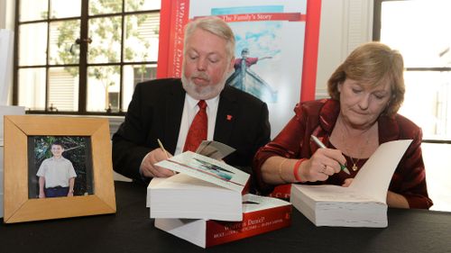 Bruce and Denise Morcombe sign their book Where is Daniel? during its launch in Brisbane. (AAP)
