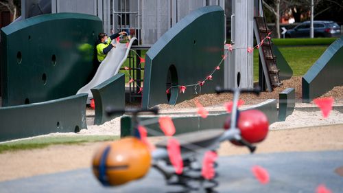 Playgrounds at the Carlton Gardens pictured being closed by local council staff due to COVID restrictions.