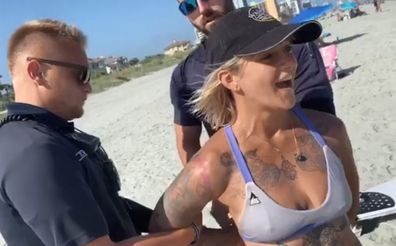 Woman handcuffed by police for wearing 'thong' swimsuit