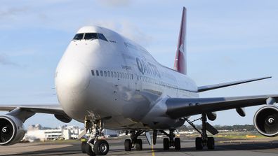 Qantas jet lands.