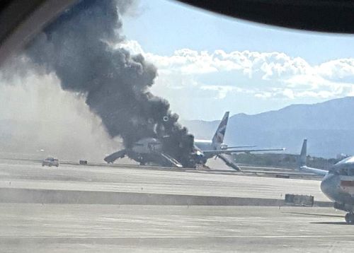 Black smoke billows from the plane. (Image: Eric Hays)