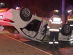 The car was flipped on its roof after crashing through the roundabout.
