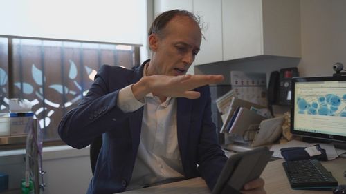 Melbourne neurologist Dr Andrew Evans can remotely ease Mickan's symptoms while he sits on his couch in Adelaide's western suburbs.