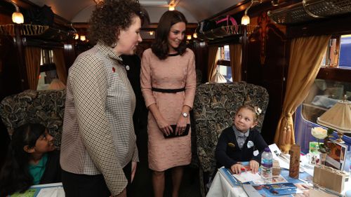 The Duchess of Cambridge speaks to children from the charities she supports onboard the Belmond British Pullman train at Paddington Station. (AAP)