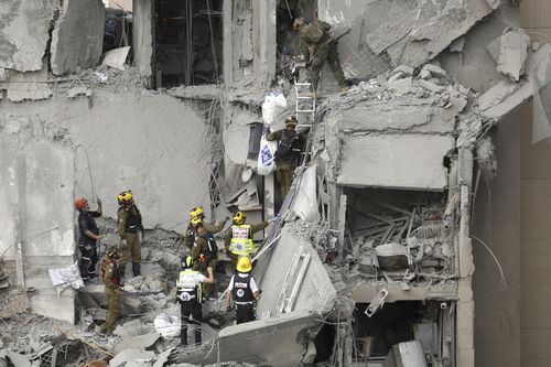 BEERSHEBA, ISRAEL - JUNE 24: Emergency responders work at a building where at least four people died in a missile strike on June 24, 2025 in Beersheba, Israel. According to Israeli authorities, Iran launched a barrage of missiles in the early hours this morning, before the start of a purported U.S.-brokered ceasefire between between the two countries. The Iranian foreign minister said that, if Israel stopped its attacks as of this morning, Iran would also end its strikes. (Photo by Amir Levy/Get