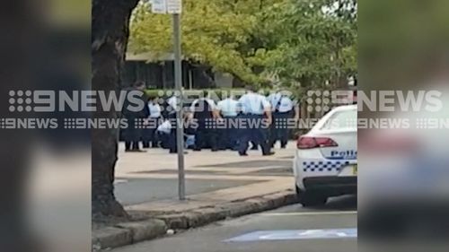 A group of officers outside Granville Police Station apprehended the man this morning.