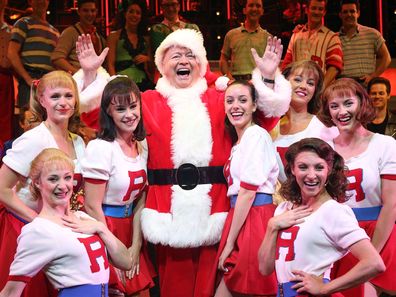 Bert Newton as Santa Claus with the cast of Grease at The Regent Theatre on December 11, 2014 in Melbourne, Australia.