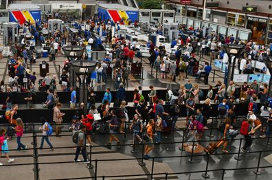 Crowds of travelers in long queue at TSA Security Check at Denver International Airport 