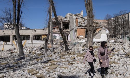 People look at damage at a school that was hit by a Russian attack ten days ago on March 20, 2022 in Zhytomyr, Ukraine. Russian forces remain on the outskirts of the Ukrainian capital, but their advance has stalled in recent days, even while Russian strikes - and pieces of intercepted missiles - have hit residential areas in the north of Kyiv. An estimated half of Kyiv's population has fled to other parts of the country, or abroad, since Russia invaded.