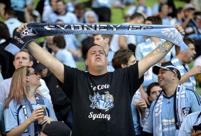 A Sydney FC supporter sings loud and proud.