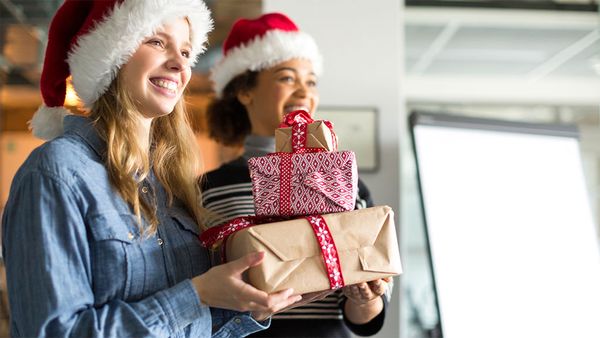 Colleagues carrying Secret Santa presents