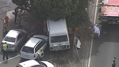 Police believe the driver of the minibus lost control before crashing into the tree and a number of parked cars. (9NEWS)