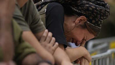 A woman cries during the funeral of Israeli Col. Roi Levy at the Mount Herzl cemetery in Jerusalem on Monday, Oct. 9, 2023. Col. Levy was killed after Hamas militants stormed from the blockaded Gaza Strip into nearby Israeli towns. 