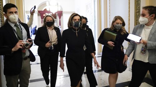 Speaker of the House Nancy Pelosi of Calif., arrives at the House chamber at the Capitol in Washington, Wednesday, Jan. 13, 2021, as the House of Representatives pursues an article of impeachment against President Donald Trump for his role in inciting an angry mob to storm the Capitol last week.