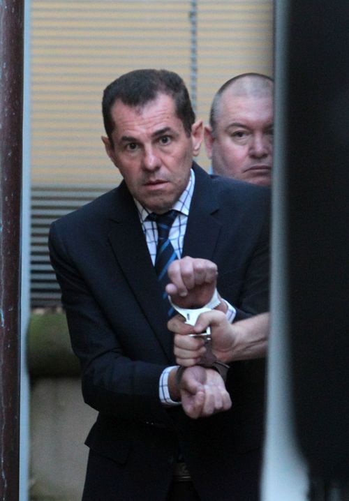 Mark Caleo is led into a prison van after his sentence was handed down at the NSW Supreme Court.