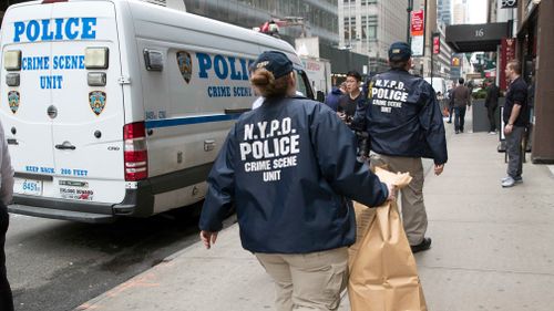 Members of the New York Police Department crime scene unit arrive at the Gotham Hotel. Picture: AP