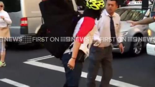 The angry scene was captured on Sydney's busy Bridge Street. (9NEWS)