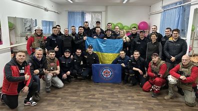 Jasmina Dedic-Hagan (middle row, second right) with volunteer doctors and local forces in Ukraine.