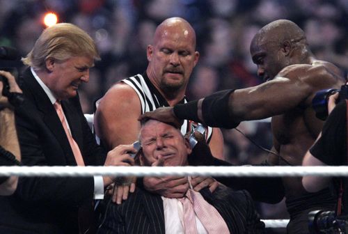 WWE Chairman Vince McMahon, center, held by "Stone Cold" Steve Austin, has his hair cut off by Donald Trump, left, and Bobby Lashley, right , after Lashley defeated Umaga at Wrestlemania 23 at Ford Field in Detroit, Sunday, April 1, 2007. (AP Photo/Carlos Osorio)