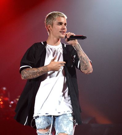 Justin Bieber singing on stage Purpose World Tour