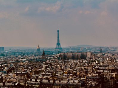 Stock image of the Eiffel Tower in Paris seen over the city skyline.