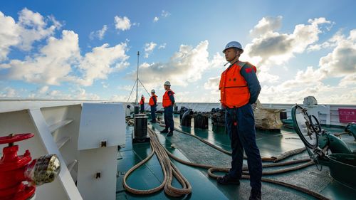 In this photo released by Xinhua News Agency, law enforcers stand duty on China Coast Guard vessel Huayang in the South China Sea, on Aug. 9, 2025. (Xu Hongyan/Xinhua via AP)