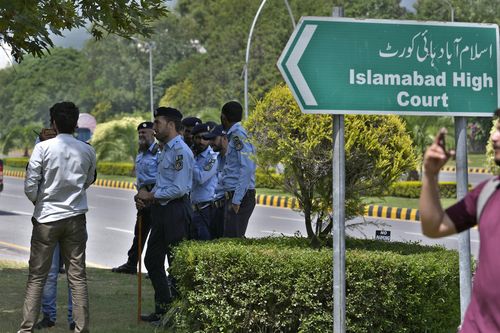 Police officers stand guard outside the Islamabad High Court in Islamabad, Pakistan, Tuesday, Aug. 29, 2023 