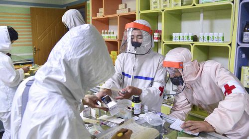 Members of the North Korean army supply medicines to residents at a pharmacy in Pyongyang.