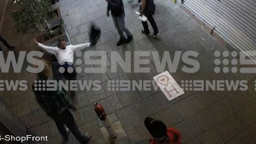 The man then hits his head on a concrete planter-box.