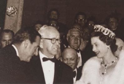 Sir Asher greets the Queen at an event.