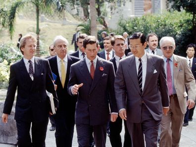 Prince Charles during a visit to Hong Kong in November 1992, accompanied by his press secretary, Dickie Arbiter (far right).