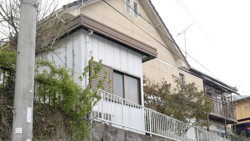 The house of Yoshitane Yamasaki, a 73-year-old man who was arrested for allegedly confining his 42-year-old son in a wooden cage placed inside a prefabricated hut next to his house in Sanda, Hyogo Prefecture. (AAP)