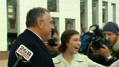 The treasurer was surprised by a woman who wanted a photo with him. (9NEWS)