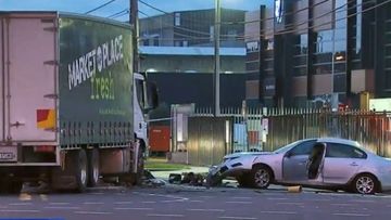 A man is fighting for his life and four others are injured after a car and truck collided in Melbourne's north.