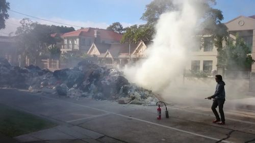Fire and Rescue NSW extinguish burning garbage. (9NEWS)